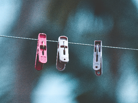 three clothes pins on a line