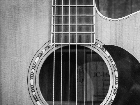 up close black and white photo of a guitar