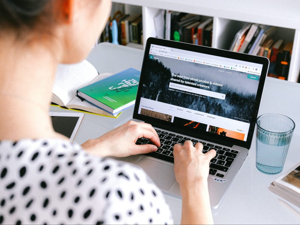 a woman typing at a laptop