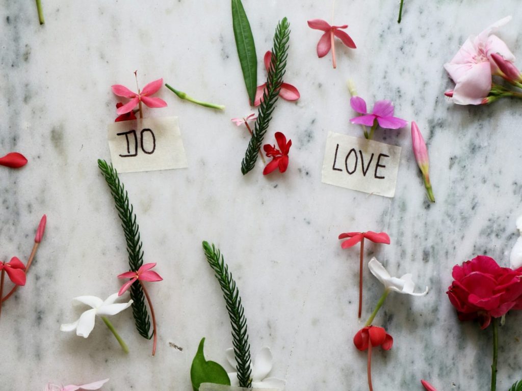 flowers and leaves scattered on a table