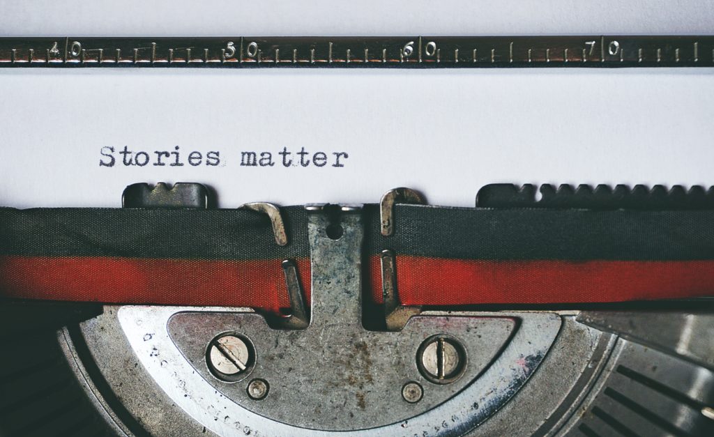 Close up of type writer with "stories matter" typed on the page.