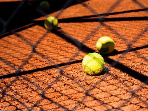 tennis balls laying on a court