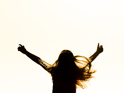 a woman in shadows with her arms outstretched