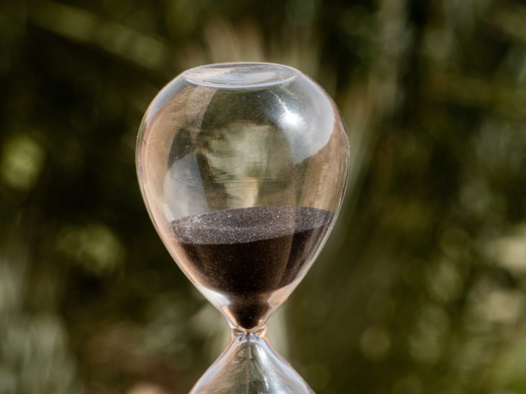 hour glass with dirt sifting through it